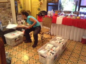 A woman packing plastic bins in a kitchen