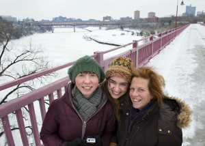 Winter view of the Mississippi River and three women on on a walk bridge