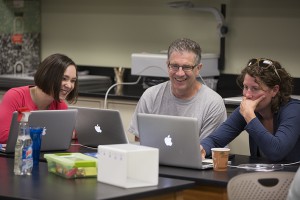 Dare and teachers work on laptops