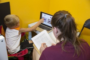 researcher works with child on numeracy
