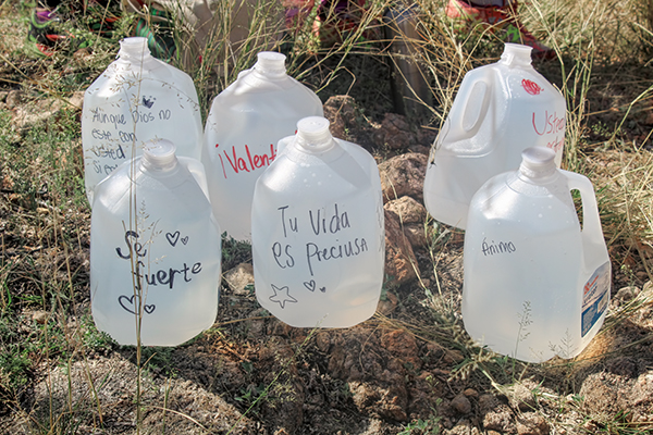 Photo of water bottles with encouraging messages such as "Your life is precious" and "Be strong."