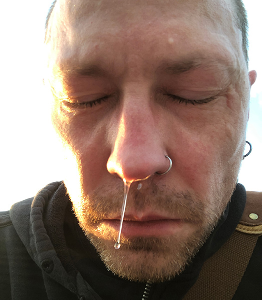 Man with liquid dripping down his nose