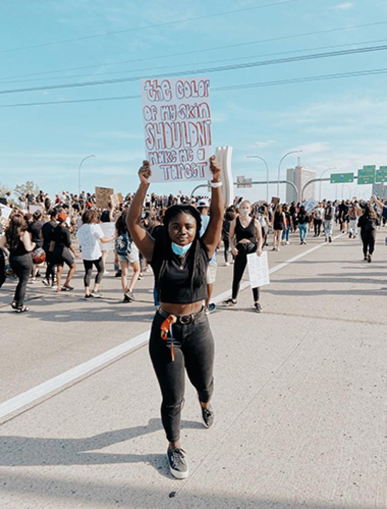 Woman holds a sign at a protest