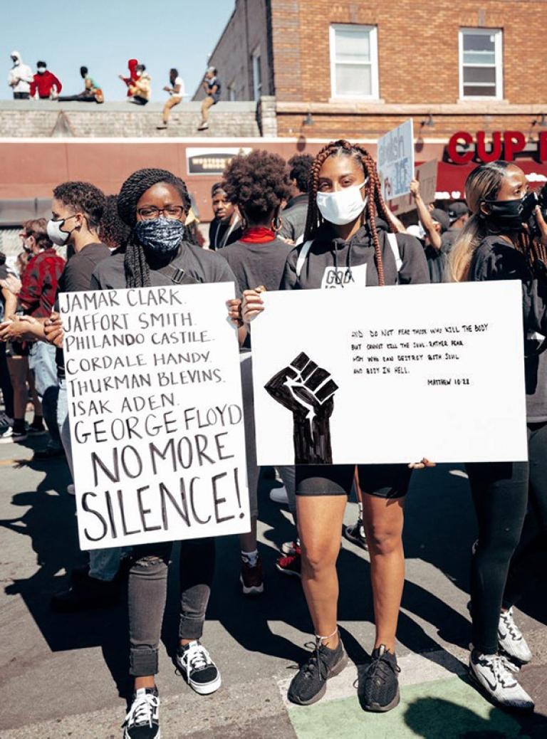 People hold signs at a protest