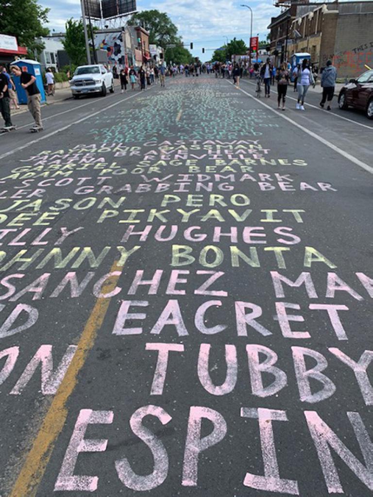 Names of police brutality victims written on a road
