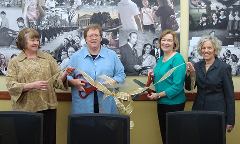 Jean Quam and colleagues cutting ribbon
