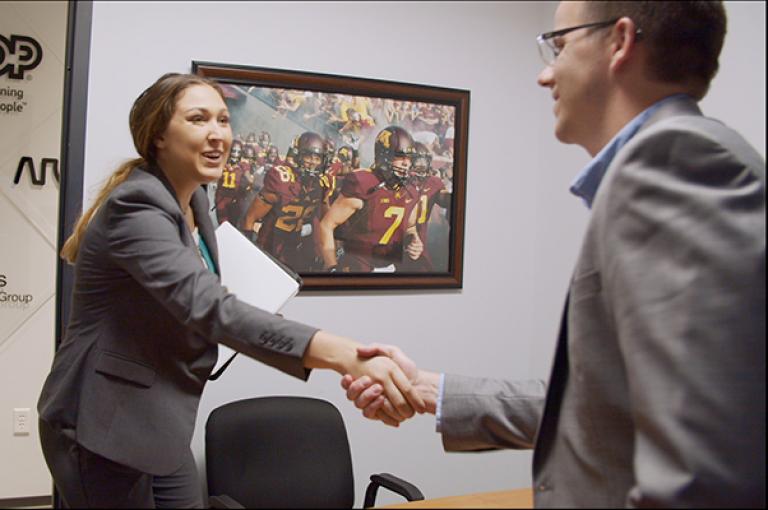 Senior Olivia Peterson shaking hands with Aaron Cole
