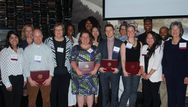 Courtney Bell-Duncan, back row, center, accepting an award at the 2015 CEHD Rising Alumni event
