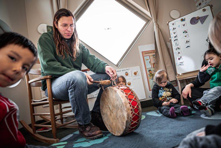 Assistant Teacher Justis Brokenrope prepares the drum for the children