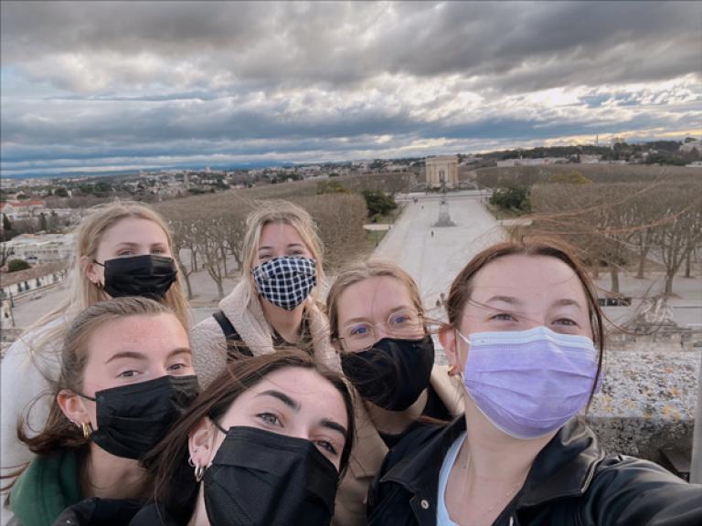 Abigail DiTolla (in purple mask) and colleagues on top of the Montpellier Arc de Triomphe in France. 