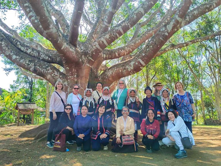 Scholars and locals under tree