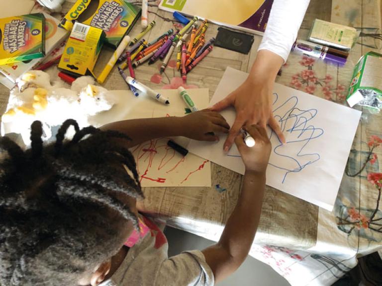 Child working on arts with parent