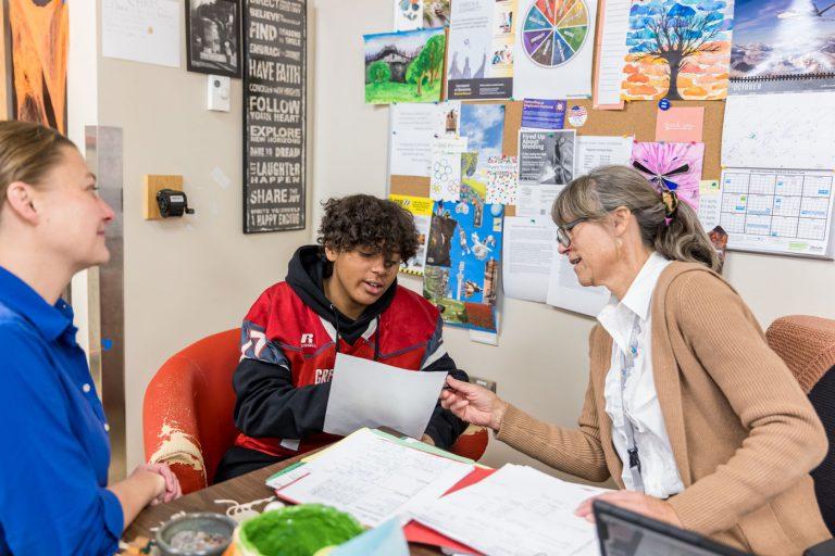 Freshman Raleon “RJ” Moore meets with mentor Bitsy Zwak (right) and Jane Ferguson, the lead ICI person for Check & Connect in St. Louis County.
