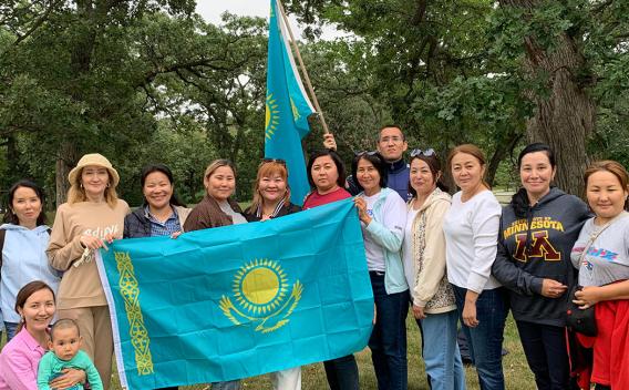 Kazakhstan scholars with flag of their homeland
