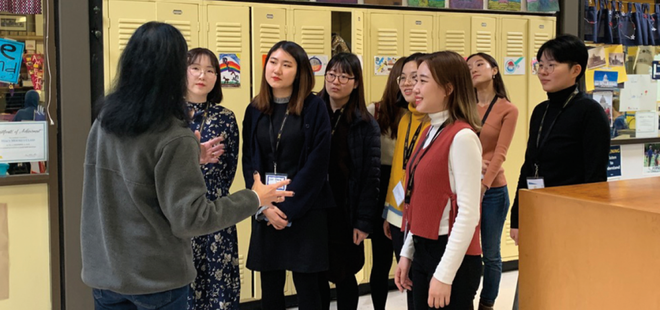 A group of 2019 SNUE students at Breck School with Peg Bailey, Breck School Lower School principal, on a school tour.