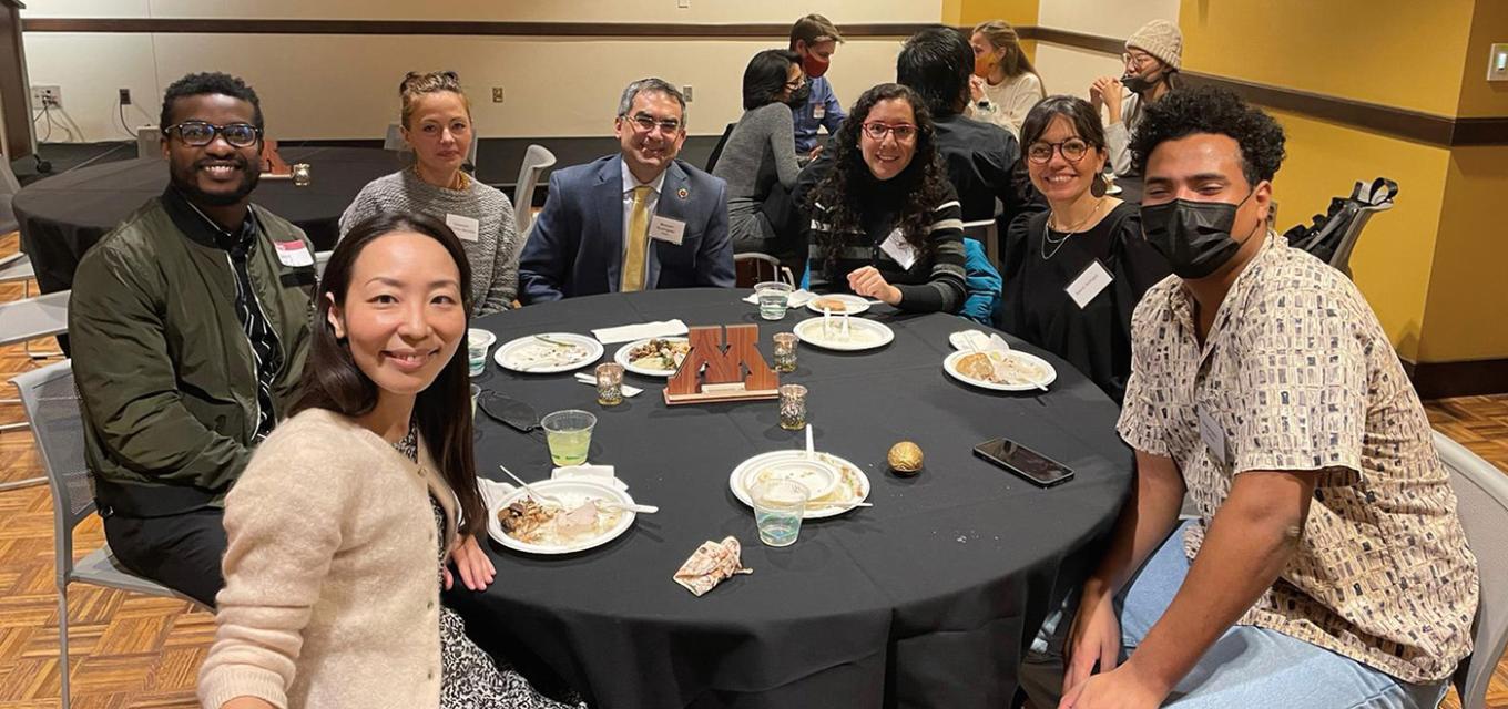 Dean Michael C. Rodriguez (middle) enjoys dinner and meeting new CEHD international students at the event.