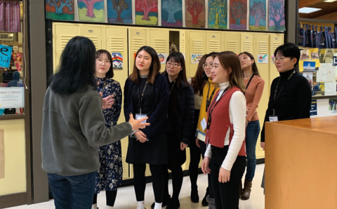 A group of 2019 SNUE students at Breck School with Peg Bailey, Breck School Lower School principal, on a school tour.