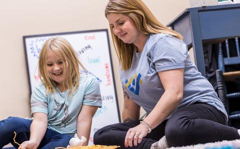 Second grader Audrianna Stone works on an activity with mentor Nikki Kern.