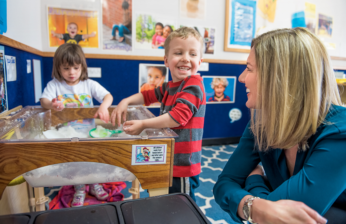 Three-year-old Mason showed pretend snow to Stephanie Carlson, a professor in the Institute of Child Development.