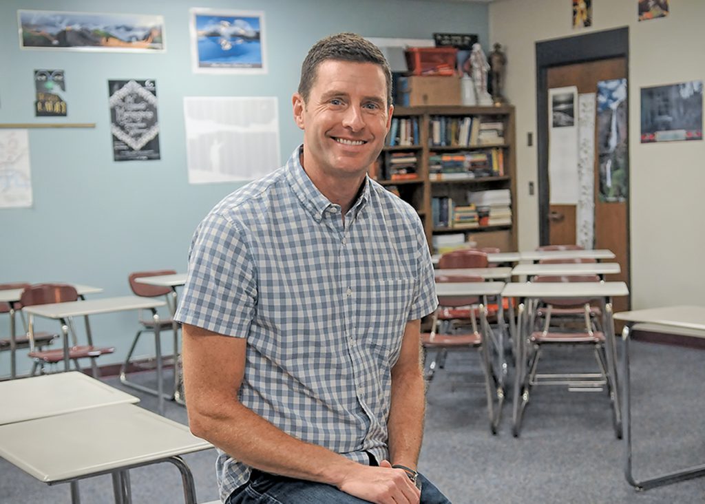 Corey Bulman poses in his classroom.