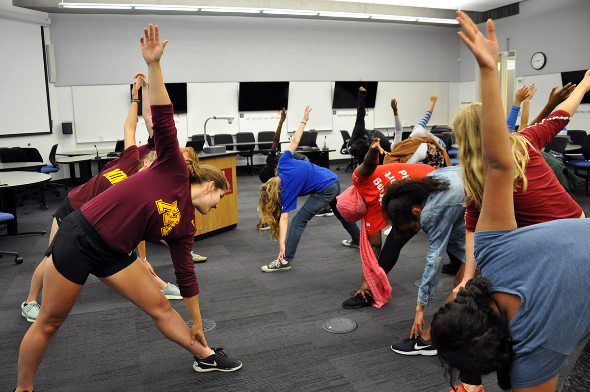 Group of UMN students stretching in a classroom