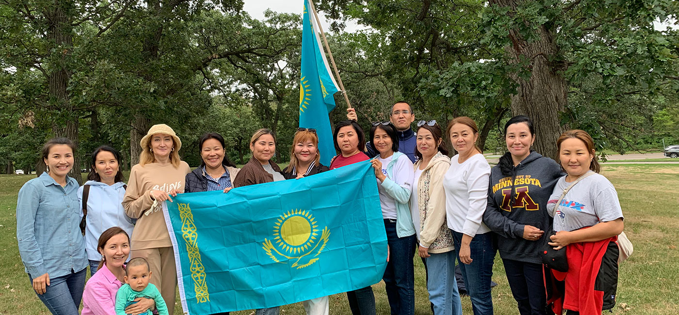 A group of people holding the Kazakhstan flag.