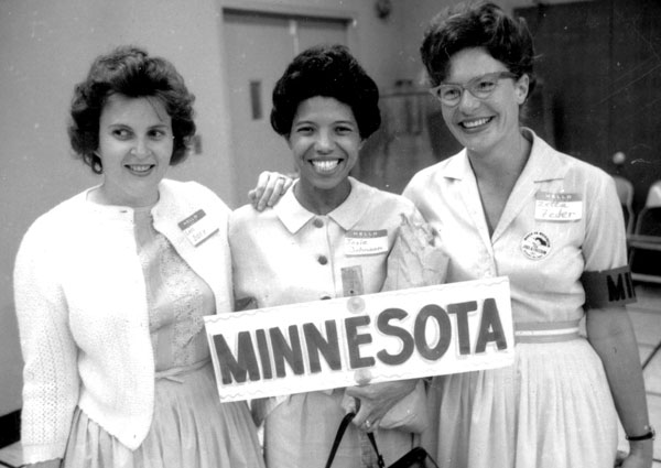 Dr. Josie R. Johnson and two other women holding a sign saying Minnesota.